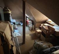 Attic room in a family house full of boxes and stored items.