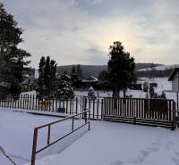 Winter scenery on the grounds - living in Jasenovce on Jesenovce street with a view of snow-covered hills.