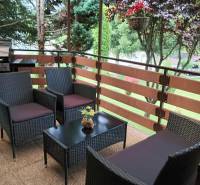 Furnished terrace with rattan seating by residential plots in Jasenovce in Jesenovce.