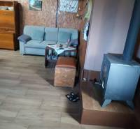 Interior with an armchair, stove, and floor with wood decor, suitable for real estate - housing.