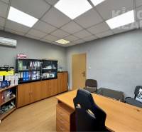 Desk, wooden decor floor, cabinets full of documents and office supplies.
