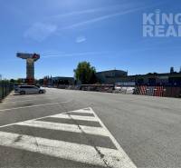 Parking lot at Petrovianska 284 in Prešov, surrounded by commercial properties and buildings.
