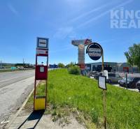Bus stop on Petrovianska Street in Prešov near commercial lands.