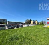 Lands - commercial on Petrovianska 284 in Prešov next to the road, with parked cars.
