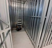 Storage space with metal walls and tools, suitable for a studio apartment.