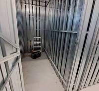 Storage space with metal shelves and tools in a studio apartment.