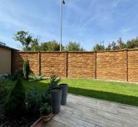 The garden of the family house on Pod privádzačom Street in Trenčín with a wooden decor terrace.