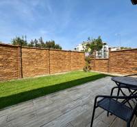 The garden of a family house in Trenčín on Pod privádzačom street with a stone fence and a terrace.