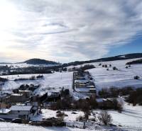 Snowy landscape with a view of plots in Horná Mičiná, designated for residential use.