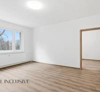 A bright interior with wood-patterned flooring in a 3-room apartment.