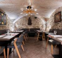 Stone walls and arched ceiling in the interior of the Gastro spaces with elegant furniture.