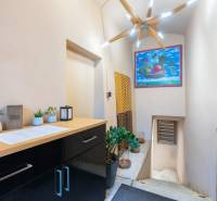 Interior of gastro spaces with decorative lighting, wooden decor, and a colorful painting.