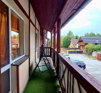 A balcony with artificial grass and a swing, facing Veľký Slavkov, Horný Slávkov.