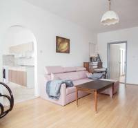 Living room in a three-room apartment with a touch of comfort and a wooden decor floor.