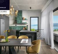 A villa with a sea view, green tiles, wooden decor flooring, dining table.