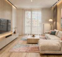 Living room in a two-room apartment with a wooden decor floor, a large painting, and a TV on the wall.