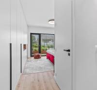 Bedroom in a family house, wooden decor flooring, large window with a view.