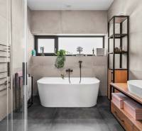 Bathroom of a family house with a freestanding bathtub and modern furniture.