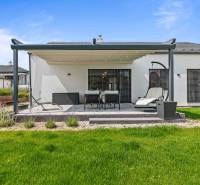 Family house on Školská Street 872/8 in Láb, terrace with outdoor seating and a swing.
