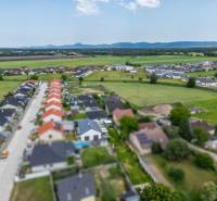 Aerial view of a row of family houses on Školská Street in Láb.