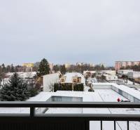 Snowy view from a 2-room apartment on Hurbanova Street in Piešťany, apartment buildings in the background.
