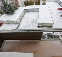 View from the balcony of a 2-room apartment on Hurbanova Street in Piešťany, parking lot with snow.