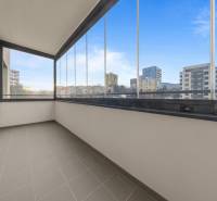 A glazed balcony of an apartment on Rudroffova Street in Bratislava-Rača with a view of the surroundings.