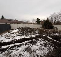 A snow-covered building plot near a family house in Veľký Grob.