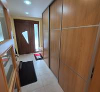Hallway in a family house with a large wardrobe and entrance door.