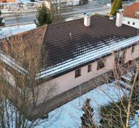 A family house in Myjava with a snow-covered roof and surroundings, view from above.