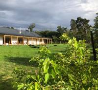 A building in the village of Láb on Láb Street surrounded by a large garden and greenery.