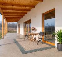 The terrace of the building in Lábe on Lábska Street, with seating and greenery.