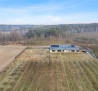 A building with photovoltaic panels on the roof in the middle of nature in the town of Láb.