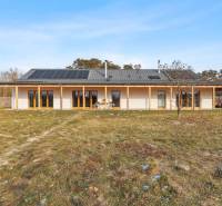 A building on Láb Street in the town of Láb, with large windows and solar panels.