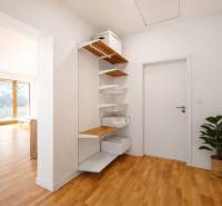 Interior with wood-patterned flooring and built-in shelving in a building.