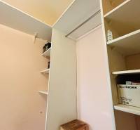 Storage space with shelves and stairs in a 3-room apartment.