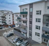 Apartment buildings with parking spaces on Slavomírova Street in Slovenský Grob.