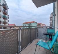 Balcony on Slavomírova Street in Slovenský Grob with a view, chairs, and a table.