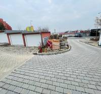 Rázdolie Street in Malé Uherce shows garages next to newly laid paving.