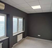 Offices with dark walls, windows with blinds, air conditioning, and radiators on the walls.