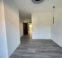 Interior of a family house with a wooden decor floor and white walls.
