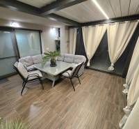 Interior of a family house with a corner seating area, table, and floor with a wood decor.