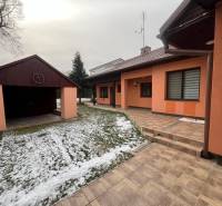 A family house in Dubovce with a garage and a terrace, surrounded by snowy winter nature.