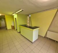 Commercial premises with tiles and a counter, light green walls, suitable for operation.