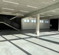 Empty commercial spaces with a concrete ceiling and staircase, floor with concrete decor.