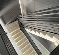 A staircase with a metal railing in commercial premises.