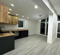 A kitchen unit with a wooden decor floor in a family house.