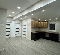 Interior of a family house with a wooden decor floor and a stylish kitchen unit.