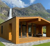 A family house in Seňa with a waterfall and mountains in the background.
