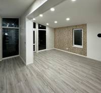Interior of a family house with a wooden decor floor and white walls.